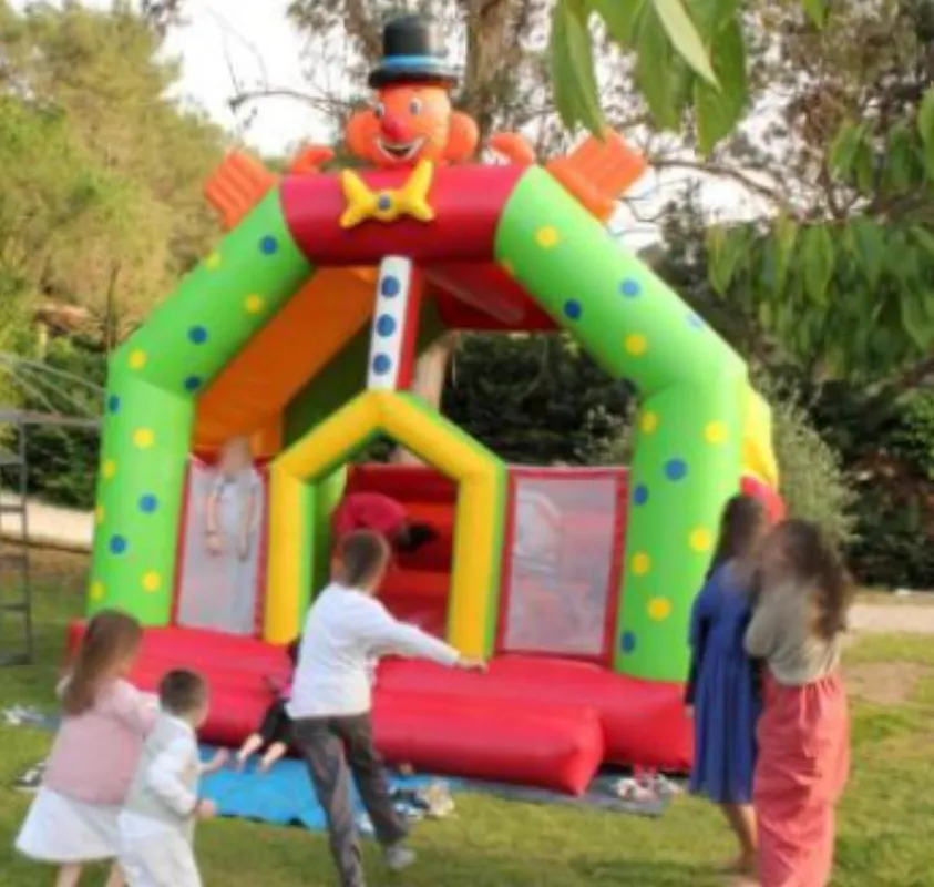Château gonflable clown avec enfants en train de jouer